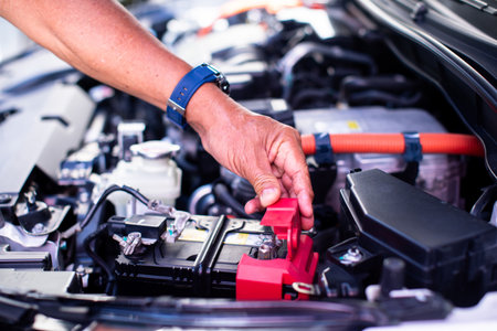 Mechanic's hands are checking engine equipment EV engine car. EV engine car engine block under hood electric vehicle high power and environmentally friendly zero emission.の写真素材
