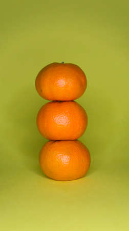 Tangerines on a yellow background, citrus subject photographyの写真素材