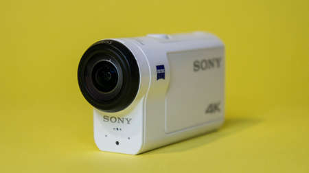 Action camera, Sony FDR-X 3000 on a yellow background