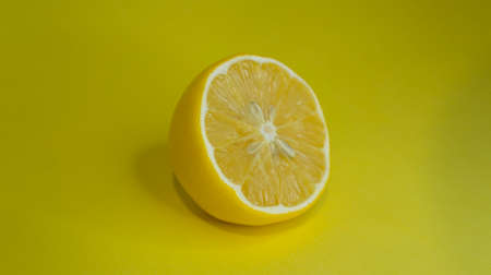 Sliced lemon on a yellow background.の写真素材