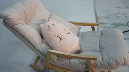 Soft toy lies on a rocking chairの写真素材