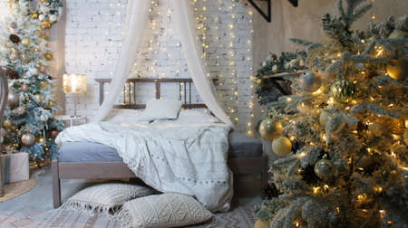 Christmas interior, New Years bed, garland on the treeの写真素材