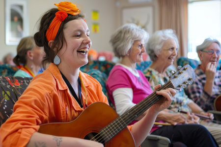 A nurse playing music for elderly people in a nursing home bokeh style backgroundの素材