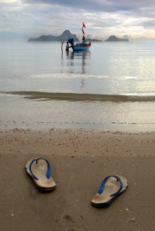 Slippers of the fisherman Thai fishermen off his slippers on the beach Walk barefooted to his ship, And preparing the boat for fishing のeditorial素材