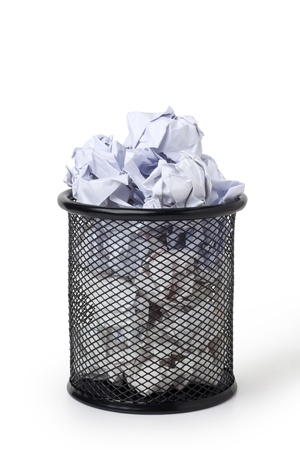 Wastepaper basket full of crumpled paperの写真素材