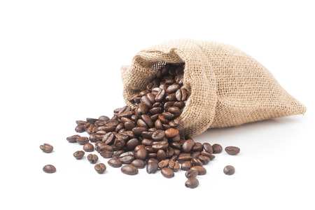 Coffee beans pouring out from the burlap sackの写真素材