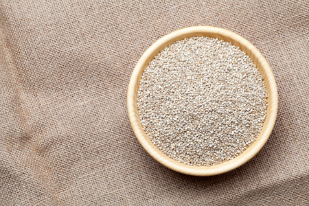 White quinoa seeds in the wooden bowl, Top viewの写真素材