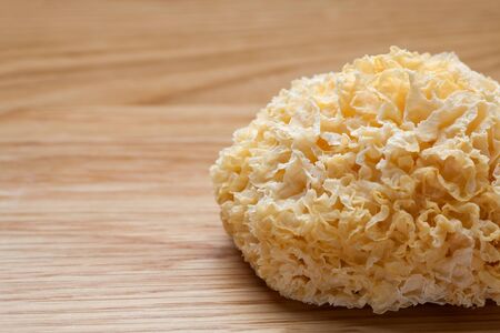 Dried white fungus (Tremella fuciformis) on wooden tableの写真素材