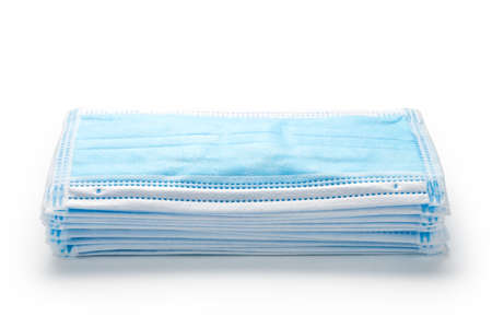 Stack of disposable medical masks on white backgroundの写真素材