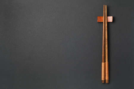 Top view of wooden chopsticks on black paper backgroundの写真素材