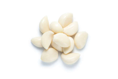 Pile of peeled garlic isolated on white background. Top view.の写真素材