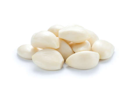 Pile of peeled garlic isolated on white background.の写真素材