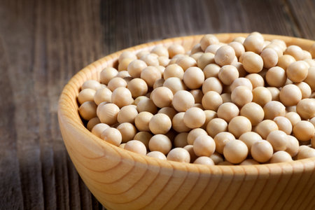 Soybean seeds in a wooden bowl. Close-up.の写真素材