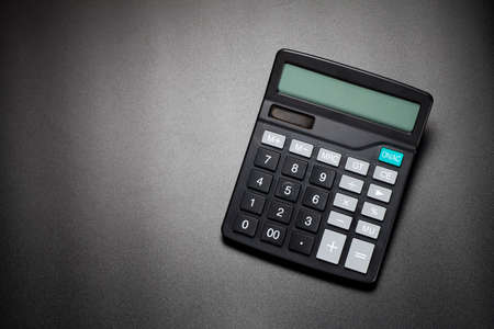 black calculator on black background. top view.の写真素材