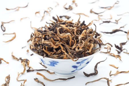 Yunnan black tea in a cup on white background.