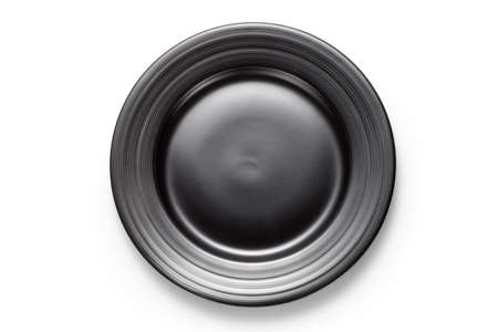 Empty black plate isolated on white background. Top view.の写真素材