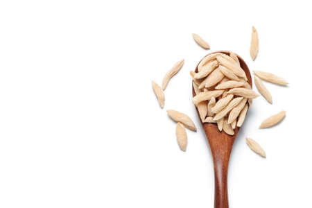 Ophiopogon âjaponicus (maidong) in a wooden spoon âisolated on white background. Chinese herbal medicine. Top view.の写真素材