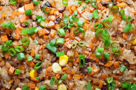 Cantonese fried glutinous rice with mushroom, corn, carrots and sausage. Chinese Food.の写真素材
