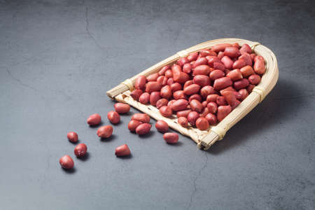 red peanuts in a bamboo dustpanの写真素材