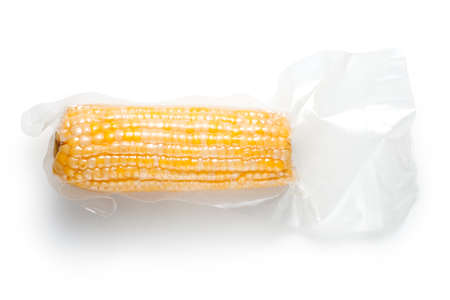 Corn cob in vacuum packaging on white backgroundの写真素材