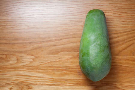 fresh green papaya on wooden tableの写真素材
