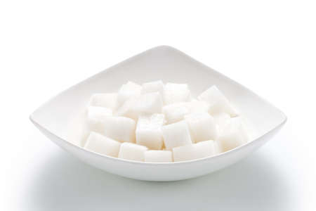 Chopped white radish in a plate isolated on white backgroundの写真素材