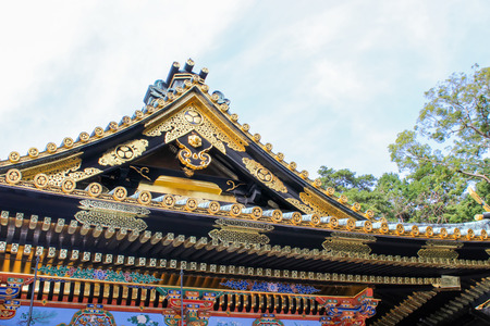Detail of the roof of japanese temple, palace surrounded by trees in the backgroundのeditorial素材