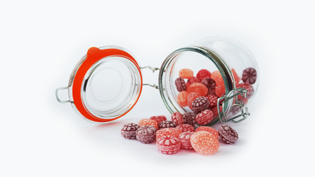 Jar with colour candy isolated on white background
