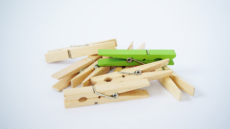 Colorful wooden clothes pegs grouped togetherの写真素材