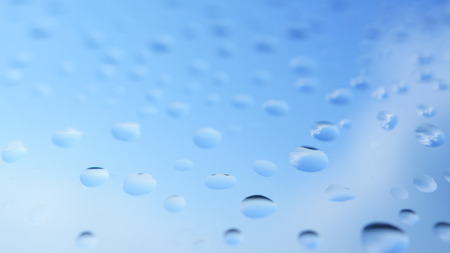 Water bubbles on the glass with blue skyの写真素材