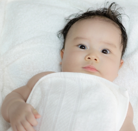 excited asian baby girl on white backgroundの写真素材