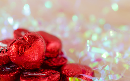 red chocolate hearts on bokeh backgroundの写真素材
