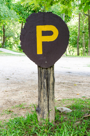 Brown old wooden parking sign.の写真素材