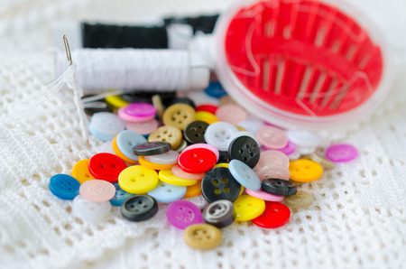 Colorful buttons, Clasper and sewing kit close up, background.