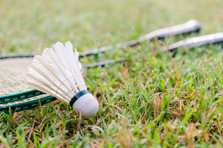 the shuttle cock and badminton racket on the grassの写真素材
