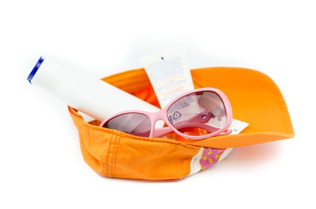 cap with sunglasses and sunscreen isolated on white background