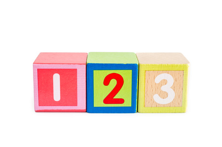 wooden toy cubes with numbers isolated on white.