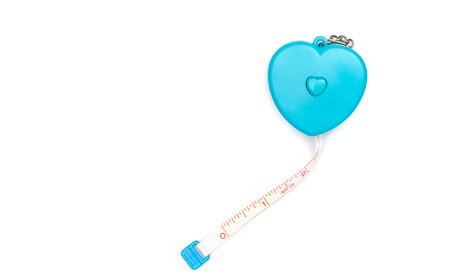 measuring tape in a heart shape isolated on white background