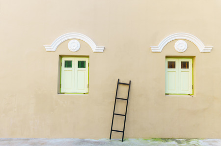 vintage windows on the wall and ladder.の写真素材