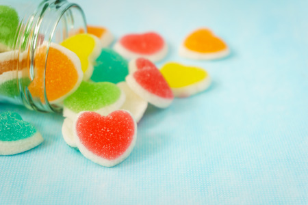 Colorful heart sign jelly on blue backgroundの写真素材