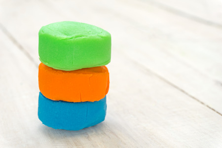 close up of colorful playdough on wooden table.の写真素材
