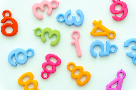Many colorful numbers on light blue background.