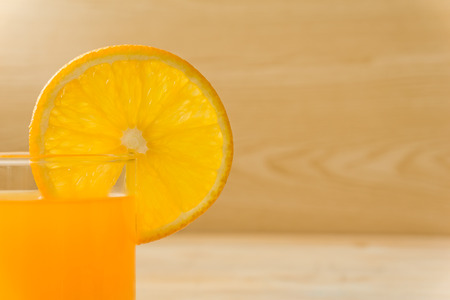 Orange juice on a wooden table - close upの写真素材