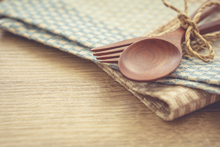 Serving spoons on  cloth lying on wooden surfaceの写真素材