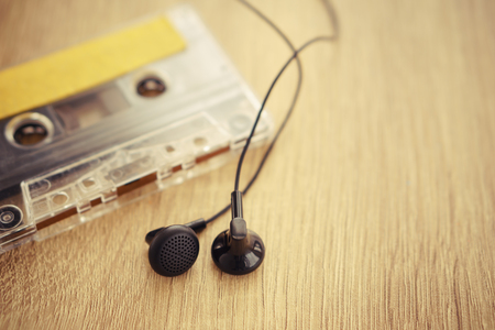 a cassette tape with headphones on wooden table - vintage styleの写真素材
