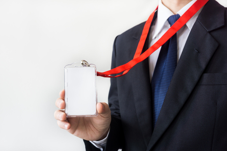 Man holding Identification white blank plastic id card.の写真素材