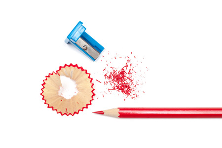 Sharpened pencil, shavings and sharpener on white backgroundの写真素材
