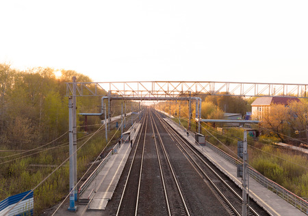 People waiting for the arrival of the train. Top view from the bridge.の写真素材