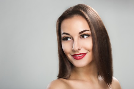Photo of a beautiful woman with long straight brown hair lookingの写真素材