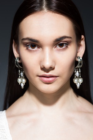 beautiful brunette with big earringsの写真素材